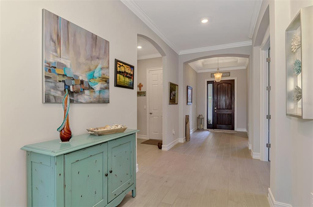 A view from an open front door into a tiled hallway leading to a living area — 292 VILLORESI BOULEVARD, NORTH VENICE, FL