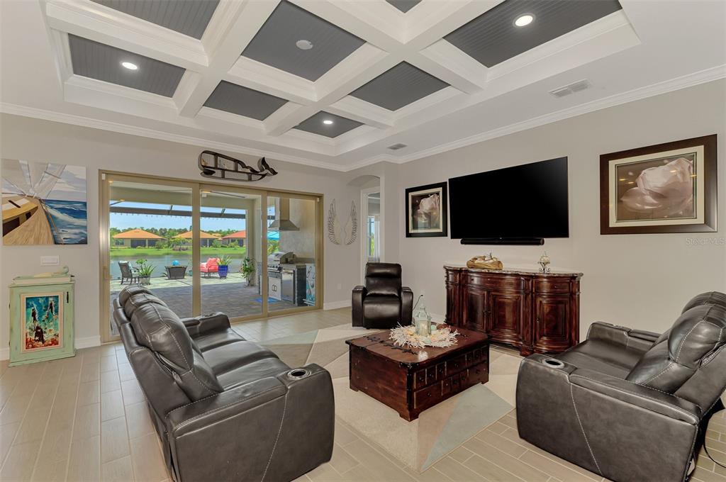 A bright entryway features light wood floors, a teal cabinet, and a dark wood door — 292 VILLORESI BOULEVARD, NORTH VENICE, FL
