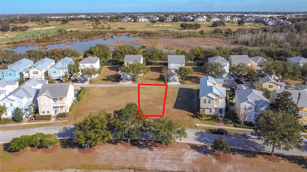 An aerial view shows a vacant residential lot outlined in red within a suburban neighborhood — 1527 FAIRVIEW CIRCLE, REUNION, FL
