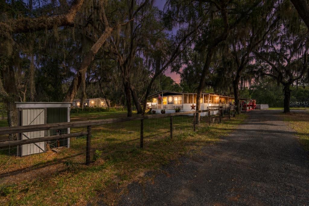 A gravel driveway leads to a single-story home surrounded by trees with hanging Spanish moss — 134 FAYE STREET, HAWTHORNE, FL