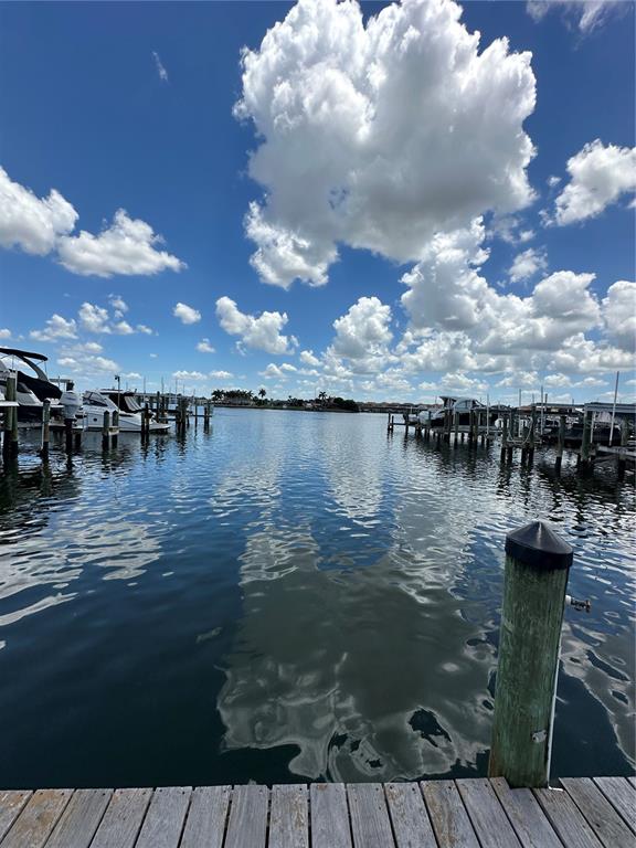 A view from a wooden dock looking out over a marina with boats and clouds — 1327 JUMANA LOOP, APOLLO BEACH, FL