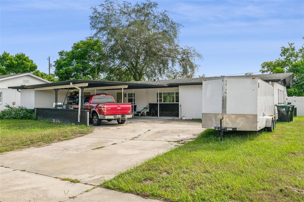 A living room features a sectional sofa, a wooden coffee table, and sliding glass doors — 4517 FETROW DRIVE, ORLANDO, FL
