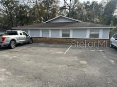 A single-story building with light blue siding and a brick base sits behind a parking lot — 2000 SE 40TH STREET ROAD, OCALA, FL