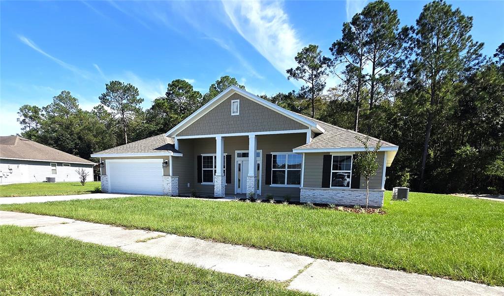 A wooden frame of a house under construction sits on a concrete slab foundation — 247 SW BELLFLOWER DRIVE, LAKE CITY, FL