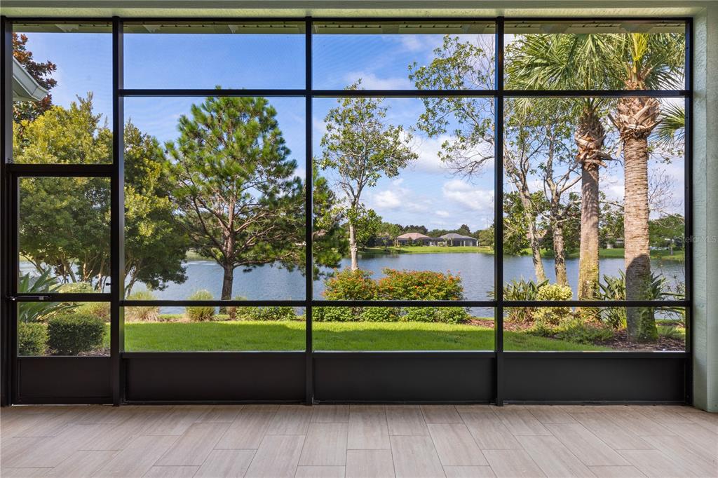 A modern kitchen features dark wood cabinets, granite countertops, a stainless steel hood, and island — 661 MAHOGANY RUN, PALM COAST, FL