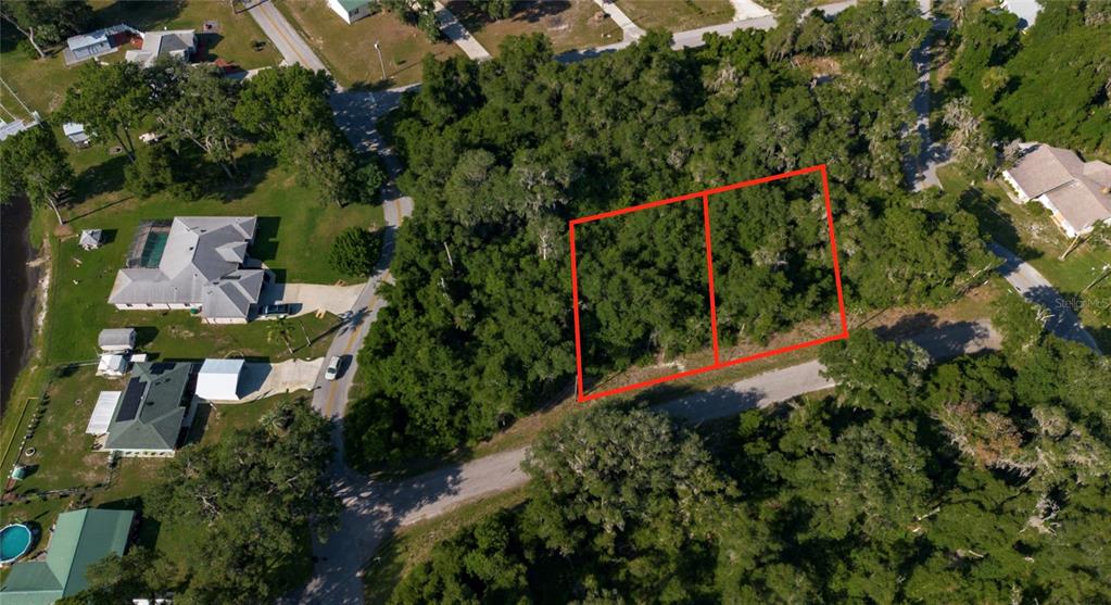 An aerial view shows two adjacent, wooded rectangular lots outlined in red near a road — 4362 E MATE LANE, HERNANDO, FL
