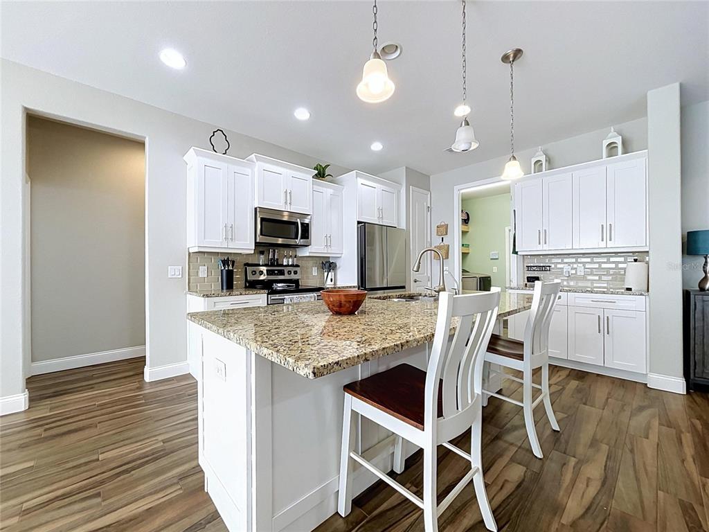 A single-story house with a gray exterior, a two-car garage, and a paved driveway — 6104 HIGHLANDS GRACE BOULEVARD, LAKELAND, FL