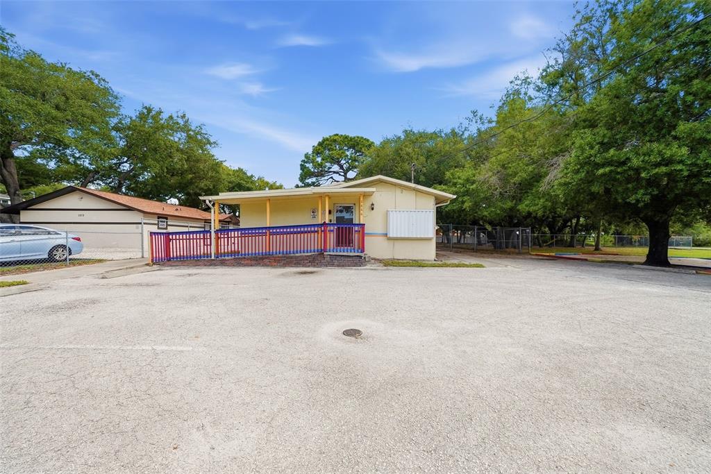 An aerial view shows a property with a building, parking area, and surrounding trees — 2886 WHITNEY ROAD, CLEARWATER, FL