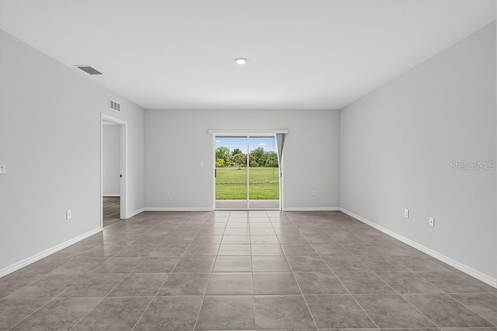 This design board displays material samples for flooring, cabinetry, and quartz countertops in a home — 6754 EQUINOX LANE, NORTH FORT MYERS, FL