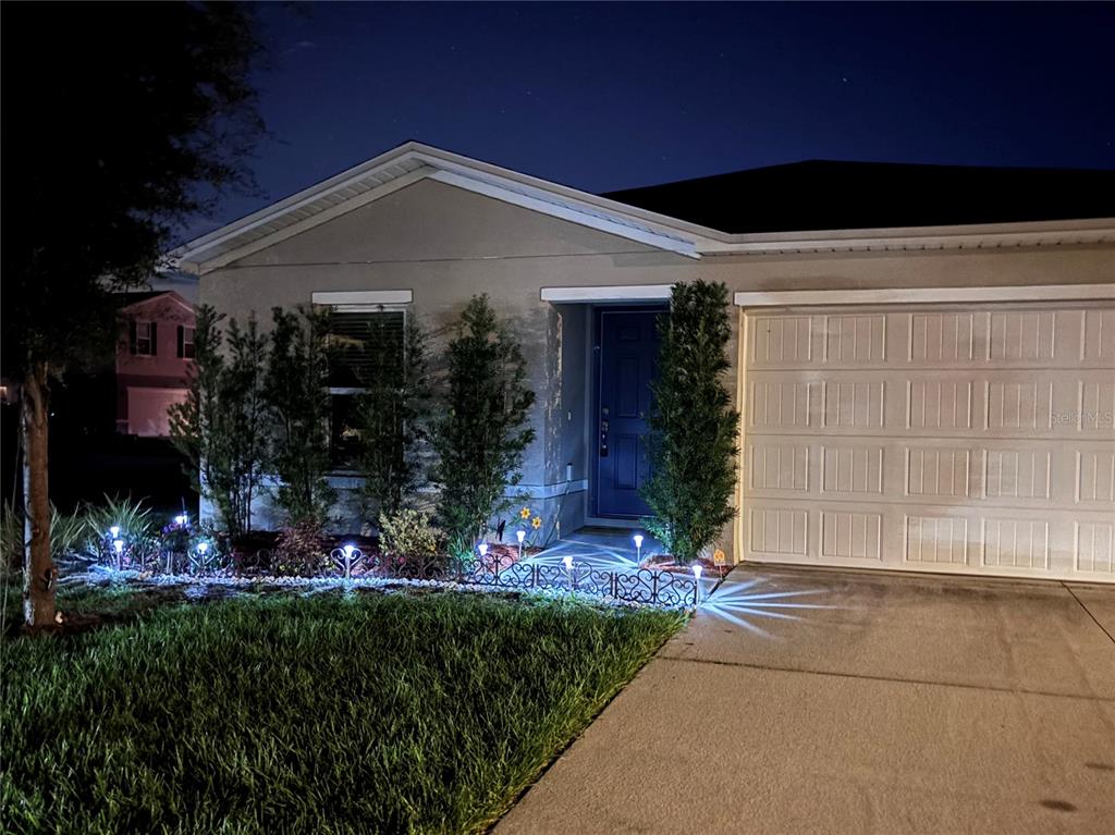 A single-story suburban house with a two-car garage and a concrete driveway — 1876 IOWA DRIVE, SUMTERVILLE, FL