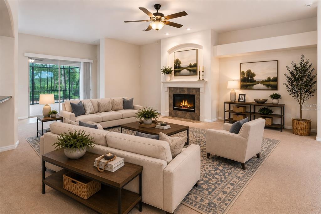 A living room features a fireplace, a ceiling fan, and neutral furniture on a rug — 597 SAND WEDGE LOOP, APOPKA, FL