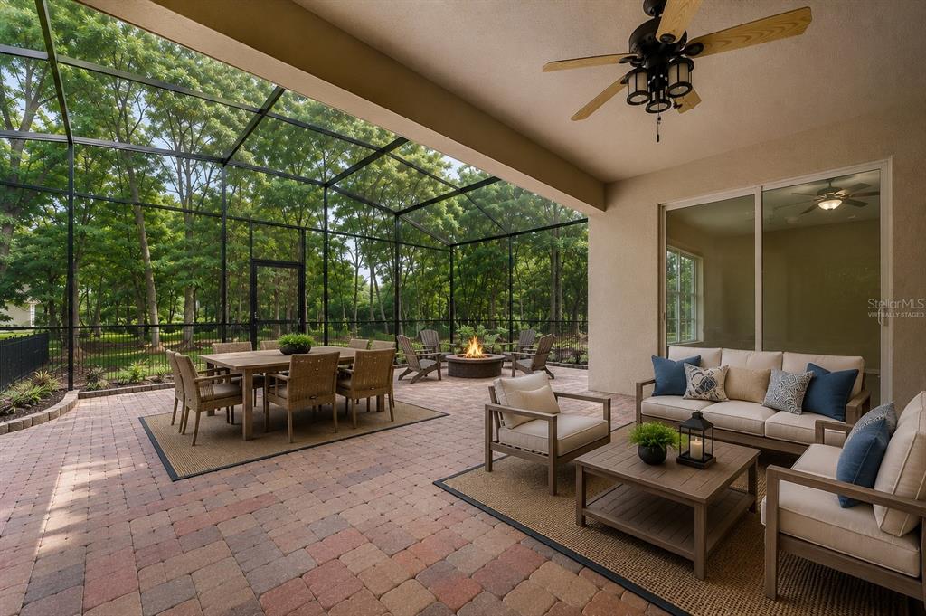 A home office features a large corner desk with built-in wooden cabinetry and wood flooring — 597 SAND WEDGE LOOP, APOPKA, FL