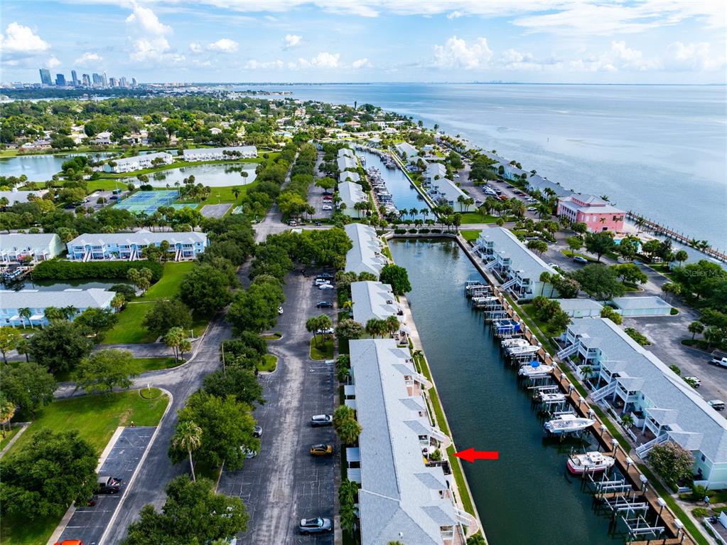 An aerial view of a waterfront condominium complex with a canal and boat slips — 5132 BEACH DRIVE SE UNIT C, ST PETERSBURG, FL