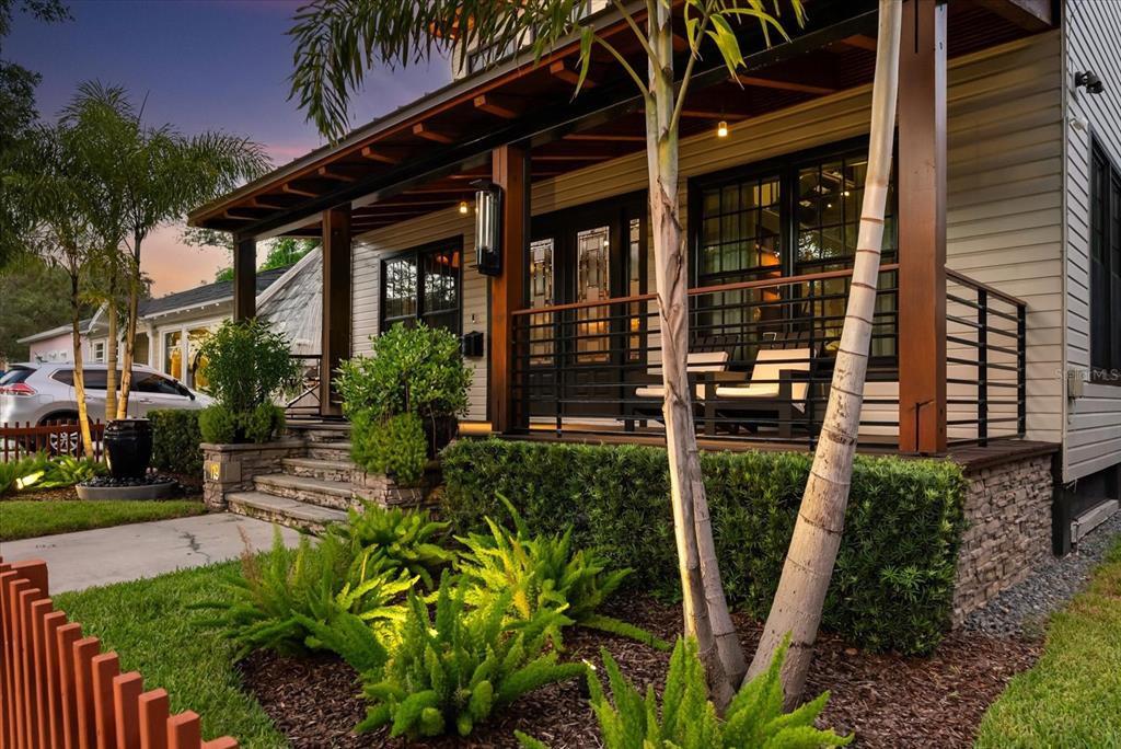 A modern two-story house with light siding, a front porch, and a wooden fence — 119 N HYER AVENUE, ORLANDO, FL