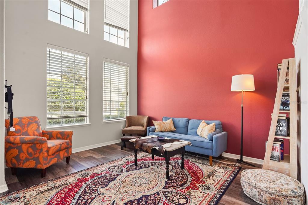 A home bar features a wooden counter, red walls, a decorative ceiling, and a gun safe — 1699 SWALLOWTAIL LANE, SANFORD, FL