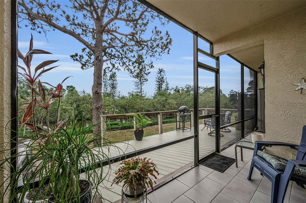 A two-story apartment building exterior features a staircase leading to an upper-level walkway — 1673 SEASCAPE CIRCLE UNIT 102, TARPON SPRINGS, FL
