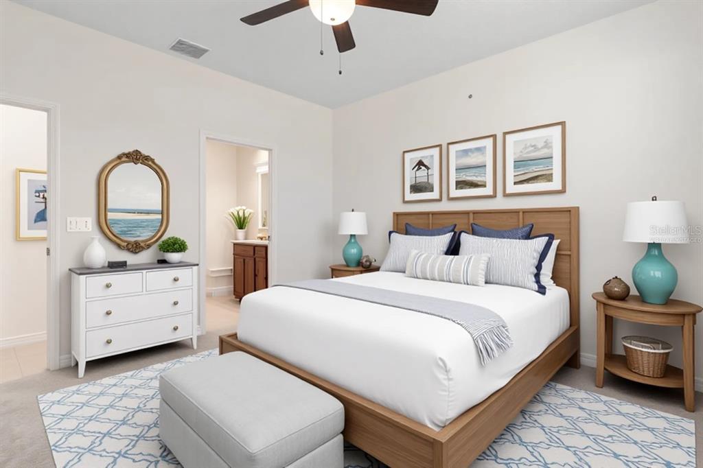 A bedroom features a wooden bed frame, white dresser, and blue-patterned rug on carpet — 3 OAKLEAF WAY, PALM COAST, FL