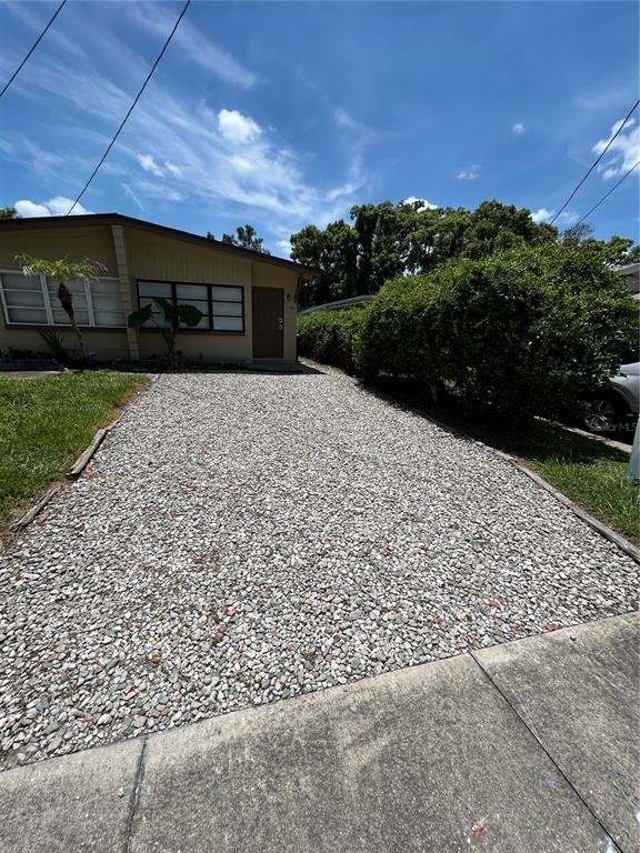 A gravel driveway leads to the front entrance of a single-story house — 1720 MILLER AVENUE, WINTER PARK, FL