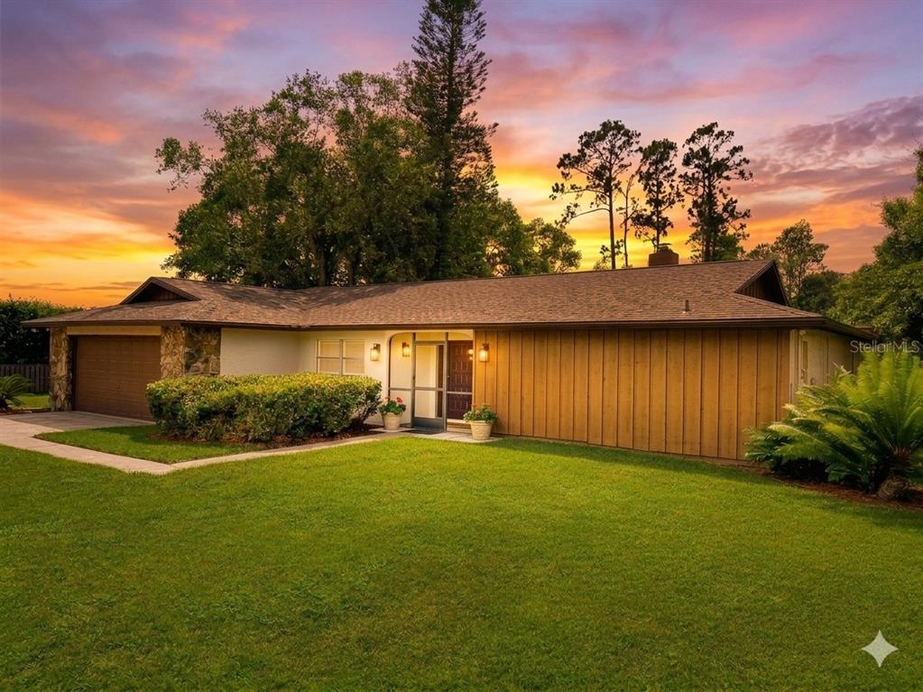 An entryway features light-colored tile flooring, beige walls, and double wood doors with sidelights — 3215 LAKE SAXON DRIVE, LAND O LAKES, FL