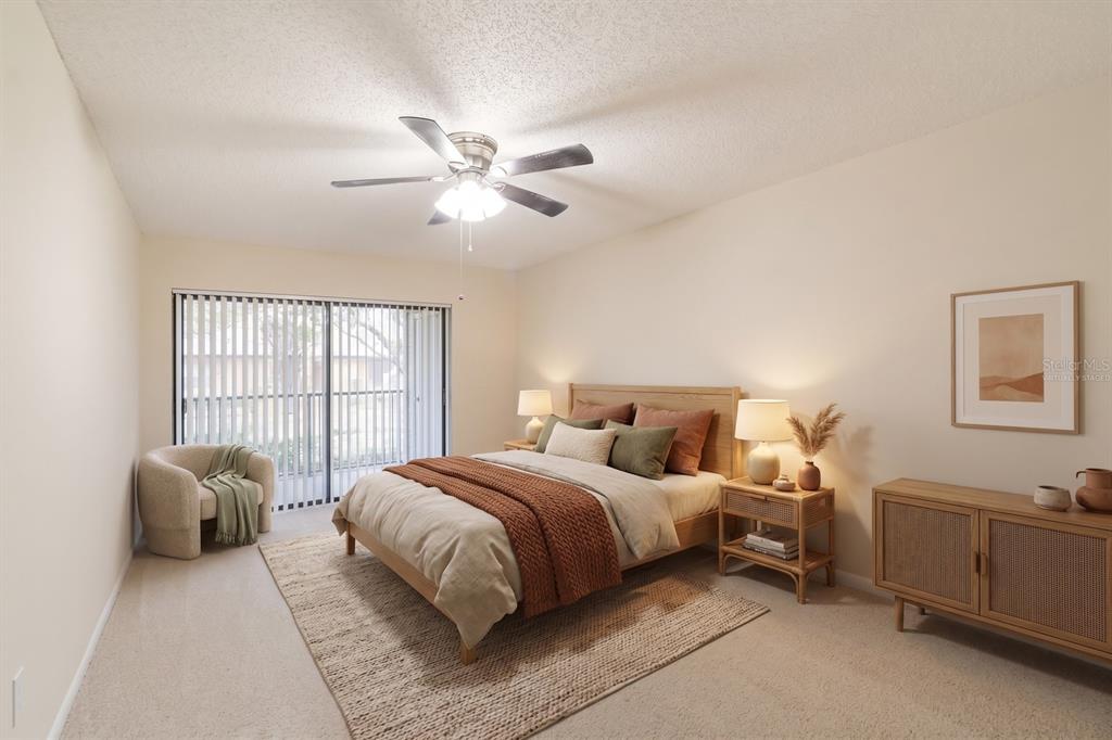 A kitchen features wood cabinetry, dark granite countertops, and stainless steel appliances — 3215 LAKE SAXON DRIVE, LAND O LAKES, FL