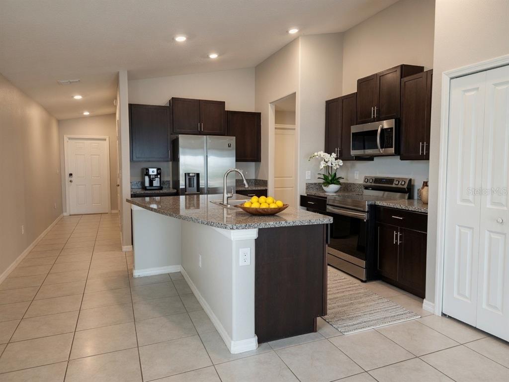 An empty bedroom with grey walls, wood-look flooring, a ceiling fan, and a window — 838 OLIVE CONCH STREET, RUSKIN, FL