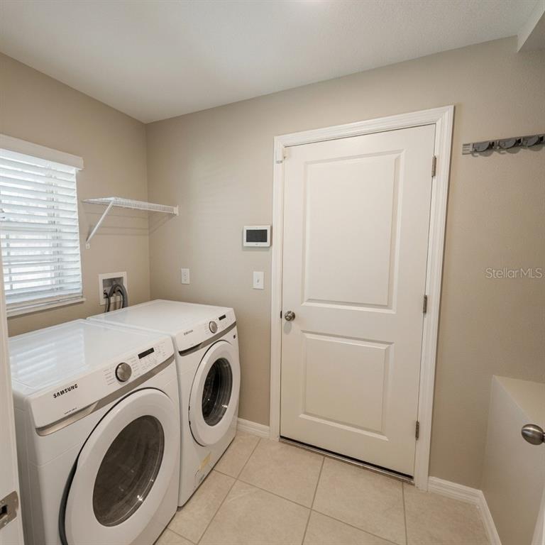 An empty bedroom features gray walls, wood-look flooring, a ceiling fan, and a window — 838 OLIVE CONCH STREET, RUSKIN, FL