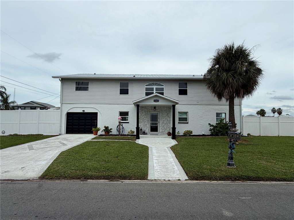 An aerial view shows a waterfront house with a boat dock and parked RV — 3173 GULFVIEW DRIVE, HERNANDO BEACH, FL