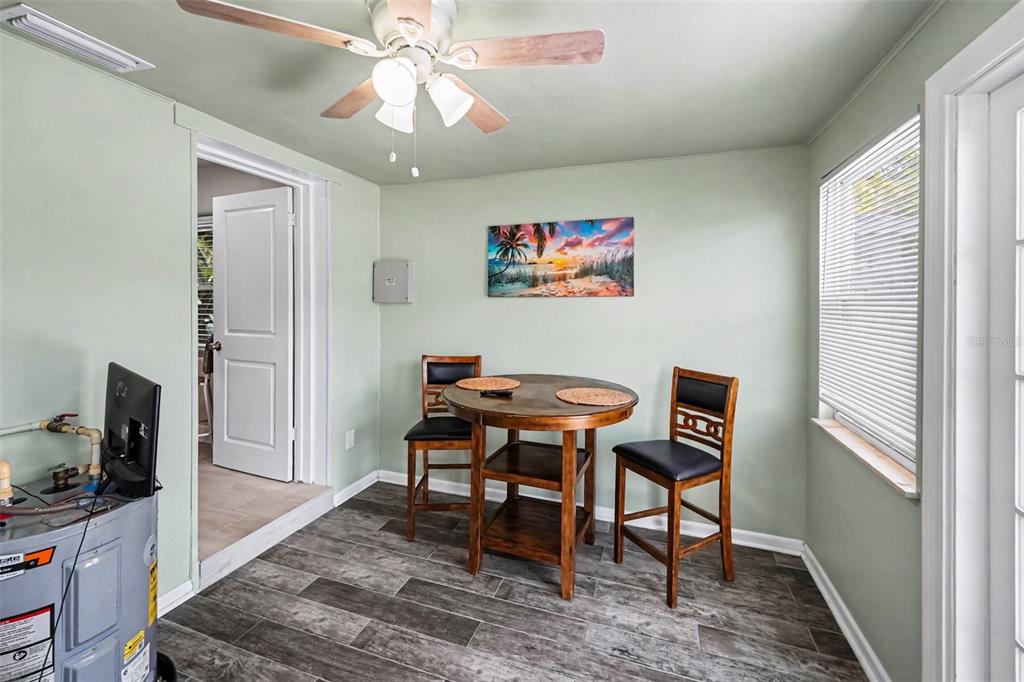 A kitchen features white shaker cabinets, a stainless steel dishwasher, and a light-colored quartz countertop — 4611 17TH AVENUE N, ST PETERSBURG, FL