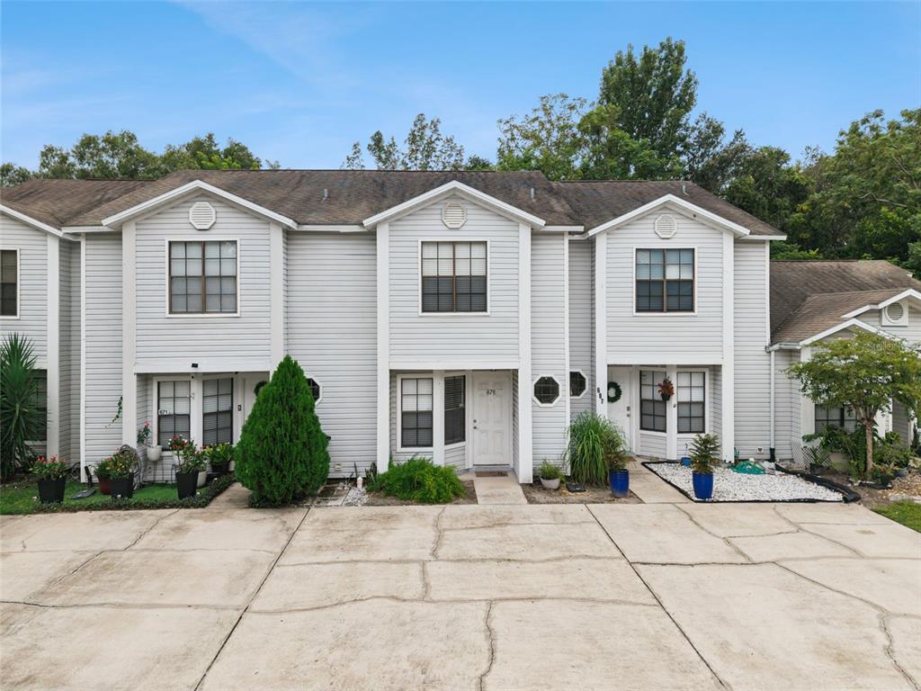 A multi-unit residential building with light gray siding and a concrete driveway in front — 679 CLEMSON DRIVE, ALTAMONTE SPRINGS, FL