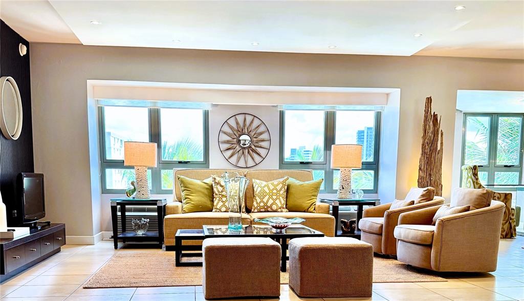 A living room features a beige sofa, two armchairs, and a central coffee table — 103 DE DIEGO AVENUE UNIT 01, SAN JUAN, PR