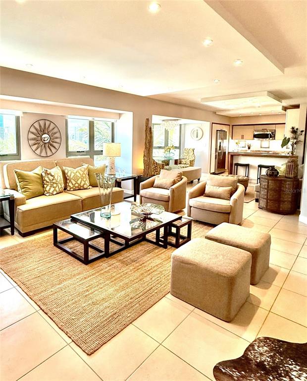 A living room features a beige sofa, two armchairs, a glass coffee table, and ottomans — 103 DE DIEGO AVENUE UNIT 01, SAN JUAN, PR