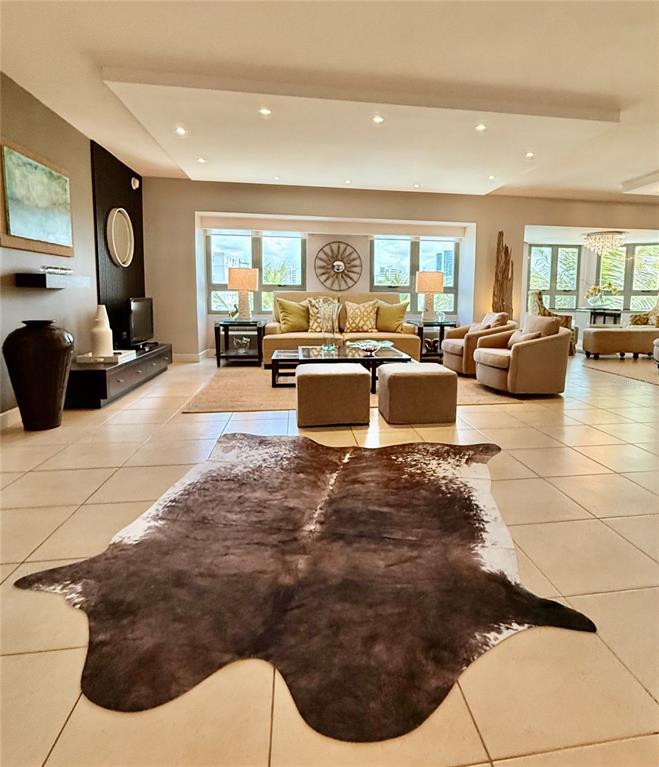 A spacious living room features tile floors, a cowhide rug, and a central seating area — 103 DE DIEGO AVENUE UNIT 01, SAN JUAN, PR