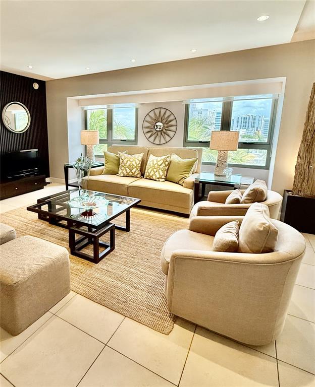 A living room features a beige sofa, two armchairs, a glass coffee table, and windows — 103 DE DIEGO AVENUE UNIT 01, SAN JUAN, PR