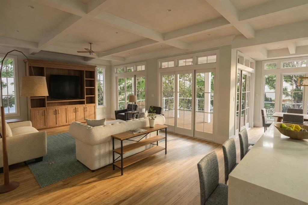 A spacious living room with a coffered ceiling, wooden built-in cabinetry, and large glass doors — 0000 SE 4TH AVENUE, CRYSTAL RIVER, FL
