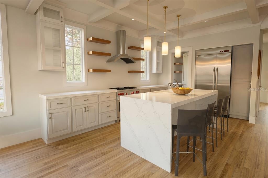 A modern kitchen features white cabinetry, a marble-topped island, stainless steel appliances, and wood flooring — 0000 SE 4TH AVENUE, CRYSTAL RIVER, FL