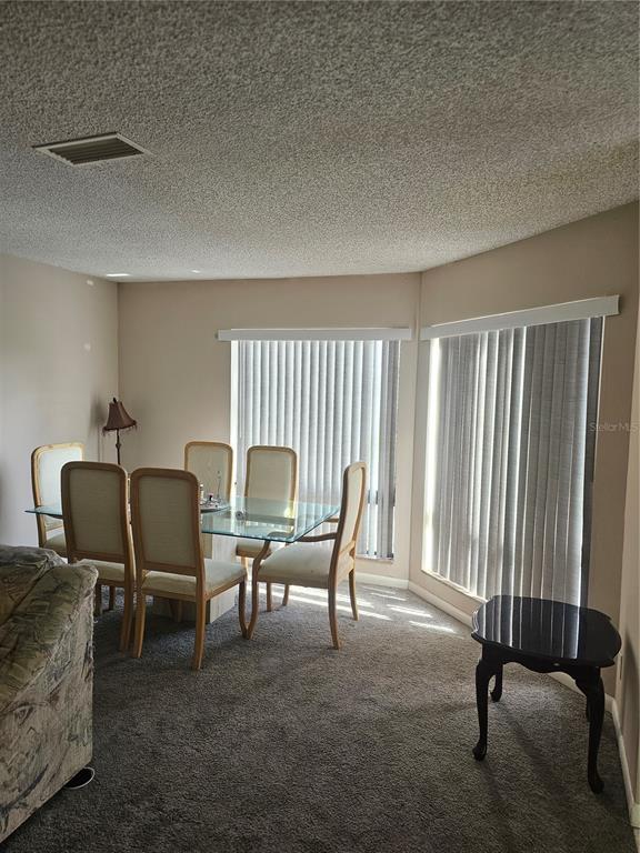 A rectangular swimming pool with a four-foot depth marker sits in front of lounge chairs — 2430 LEMON TREE LANE UNIT 2I, ORLANDO, FL