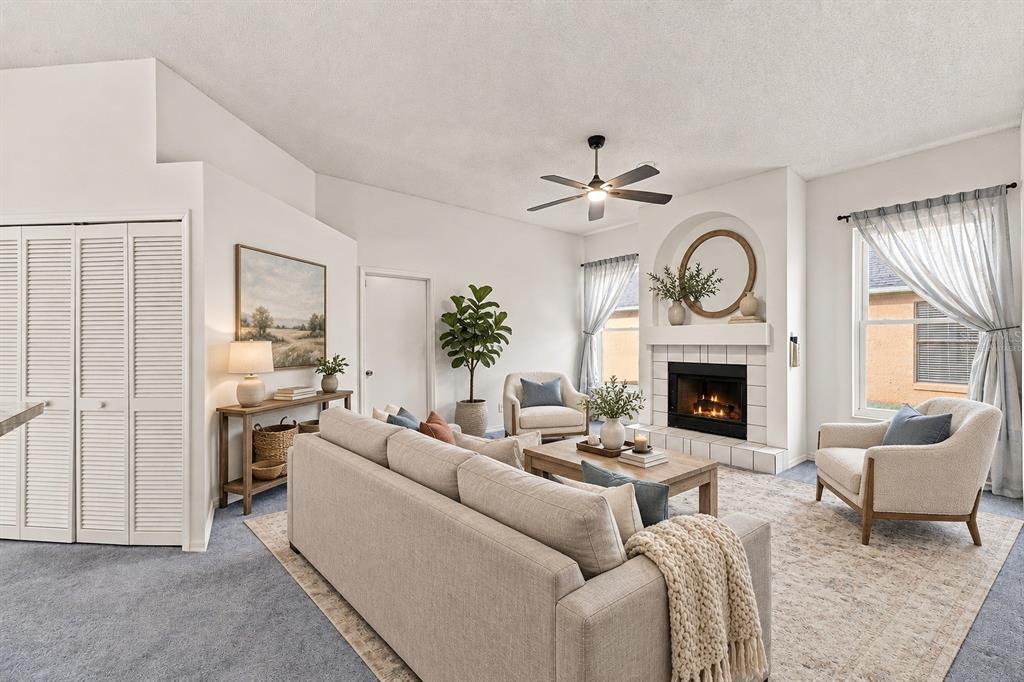 A living room features a fireplace, a beige sofa, two armchairs, and a ceiling fan — 5531 DELANO LANE, ORLANDO, FL