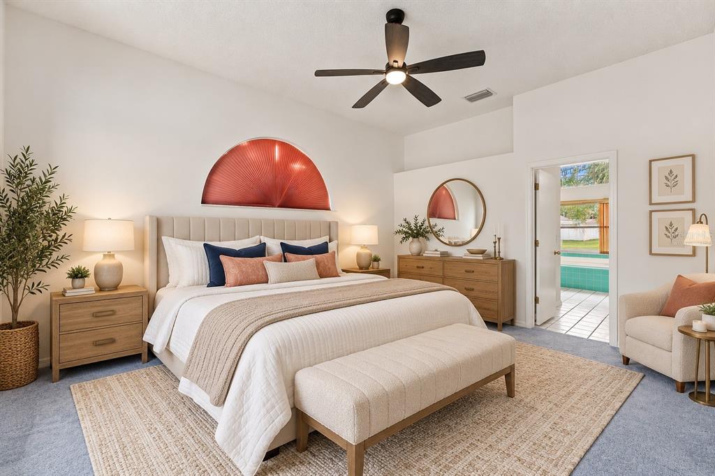 A bedroom features a king bed, a ceiling fan, a dresser, and an attached bathroom — 5531 DELANO LANE, ORLANDO, FL