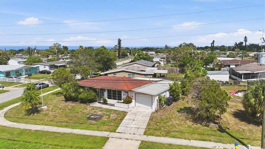 An aerial view of a single-story house with a red roof and attached garage — 4751 S BISCAYNE DRIVE, NORTH PORT, FL