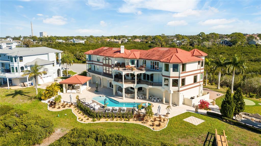 An aerial view shows a large multi-story house with a red tile roof and pool — 2115 ALEXIS COURT, TARPON SPRINGS, FL