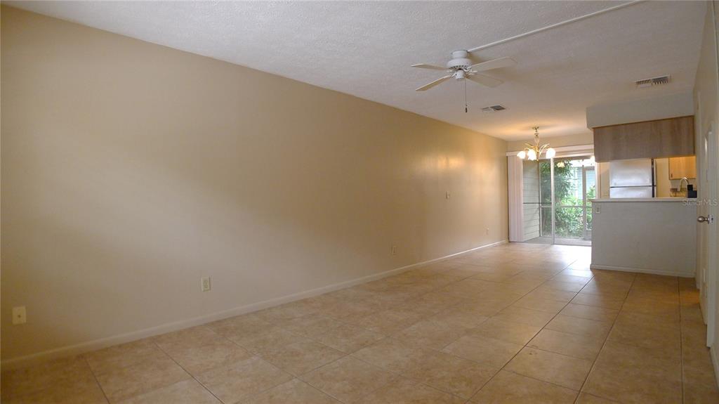 A kitchen features wood cabinets, stainless steel appliances, a double sink, and tile flooring — 608 LYNCHBURG DRIVE, BRANDON, FL