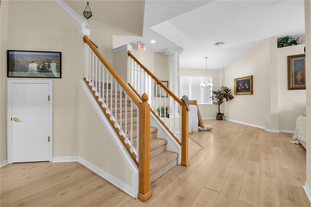 A staircase with wooden railings and carpeted steps leads to an upper level in a home — 655 MONTARA DRIVE, DAVENPORT, FL