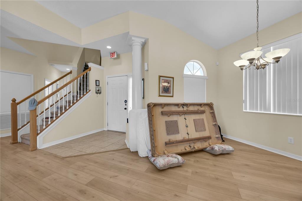 An entryway with a staircase, tile flooring, and a dining area with wood-look flooring — 655 MONTARA DRIVE, DAVENPORT, FL