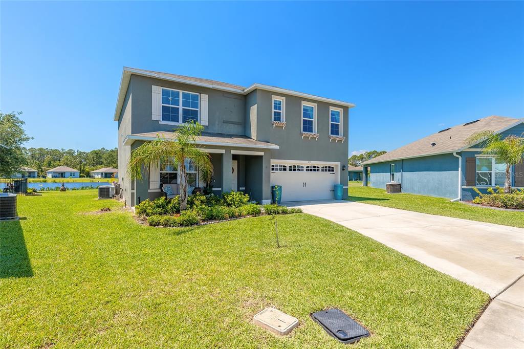 A two-story suburban house with a gray exterior, a front porch, and a two-car garage — 319 SUNSET VIEW DRIVE, EDGEWATER, FL