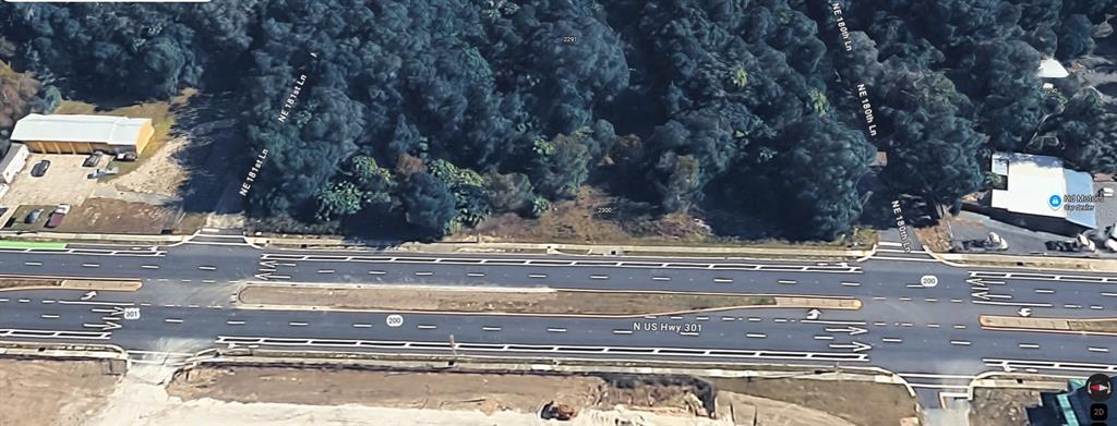 An aerial view shows a vacant lot situated between two side streets along a highway — 18011 N US HWY 301, CITRA, FL