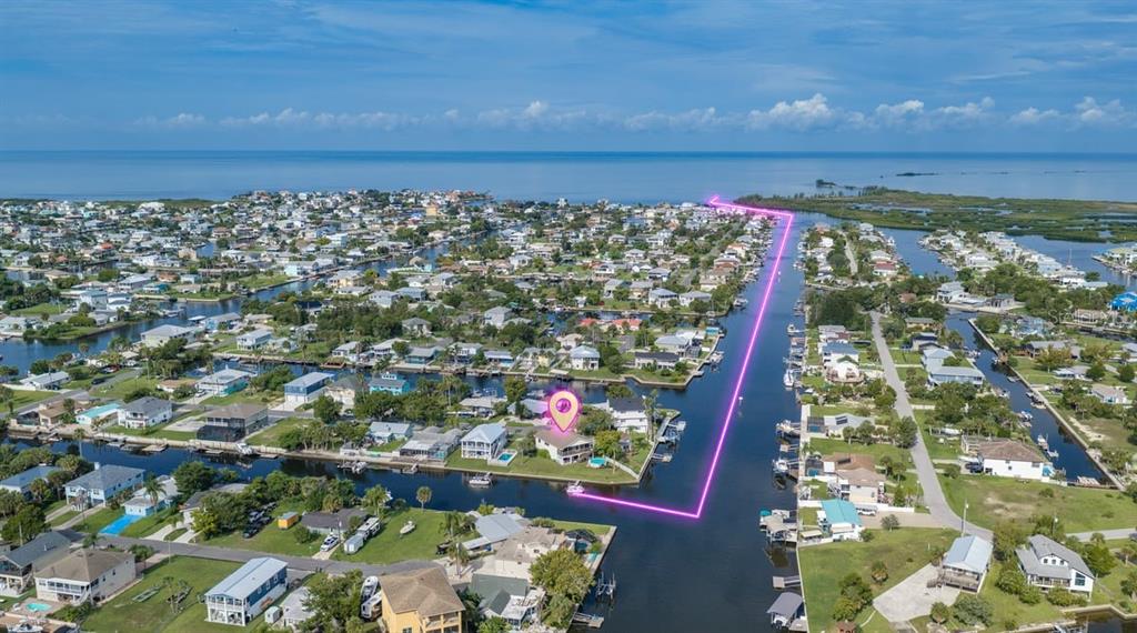 An aerial view shows a waterfront house with a pink location pin on a canal — 4514 NEPTUNE DRIVE, HERNANDO BEACH, FL