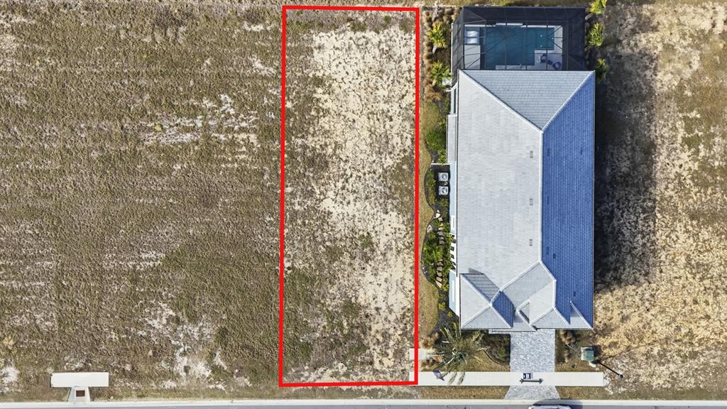 An aerial view shows a vacant rectangular lot outlined in red next to a house — 87 CORONADO ROAD, FLAGLER BEACH, FL