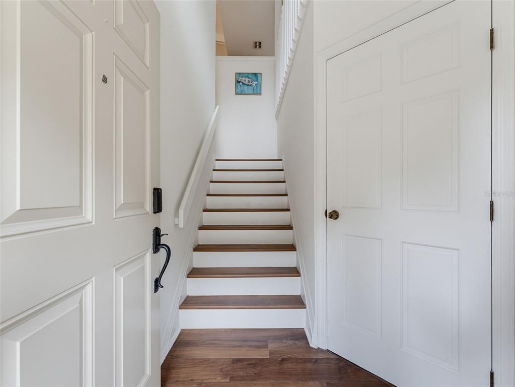 This is a floor plan showing a garage and a foyer with stairs — 1491 MAHOGANY LANE UNIT 1491, PALM HARBOR, FL