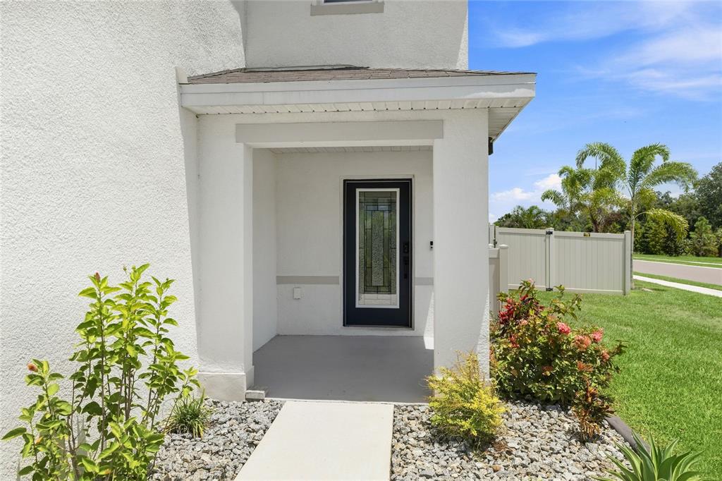 A two-story white stucco house with a two-car garage and a concrete driveway — 12272 HIGH ROCK WAY, PARRISH, FL