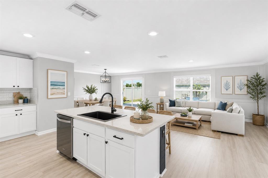 An entryway features white board-and-batten wainscoting, light wood-look flooring, and a staircase with carpet — 12272 HIGH ROCK WAY, PARRISH, FL